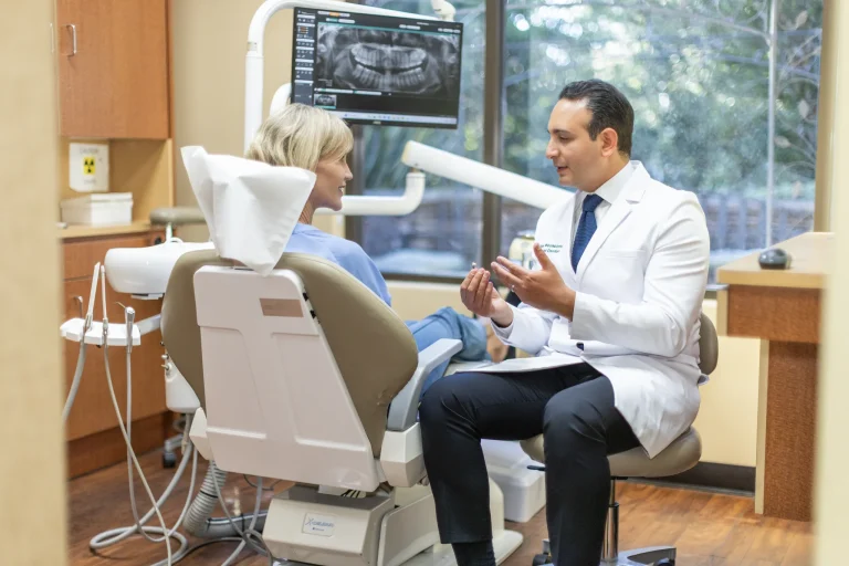 Dr. Ben explaining with a dental model beside the X-ray screen